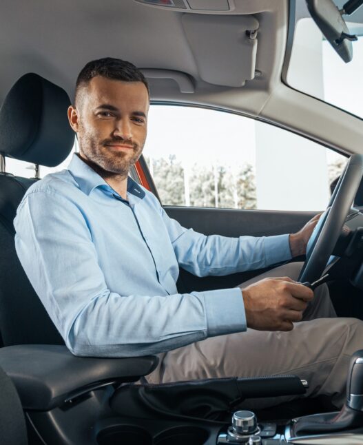 Young businessman in a car rental service. Test drive concept